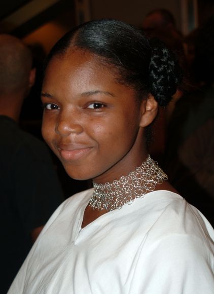 Silver graduated knotted chain mail choker worn by incredibly beautiful young girl.