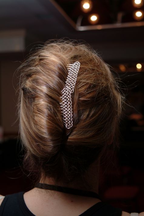 Jamie's hair, caught up with combs.
