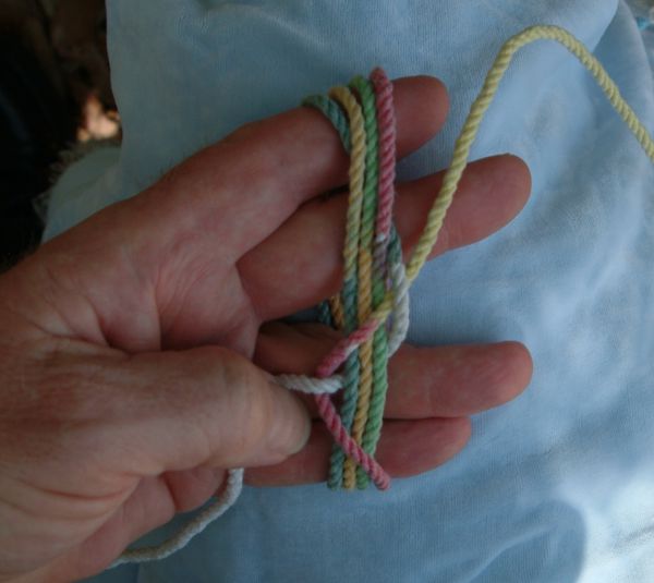 Tying a seven-lead twelve-bight knot in hand.