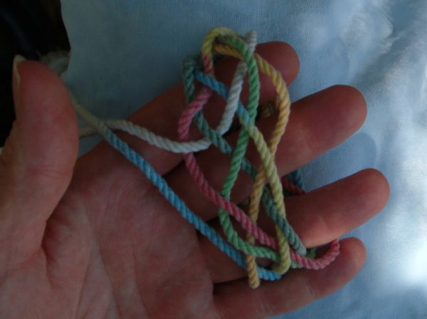 Tying a seven-lead twelve-bight knot in hand.