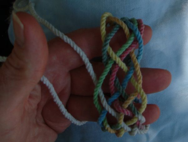 Tying a seven-lead twelve-bight knot in hand.