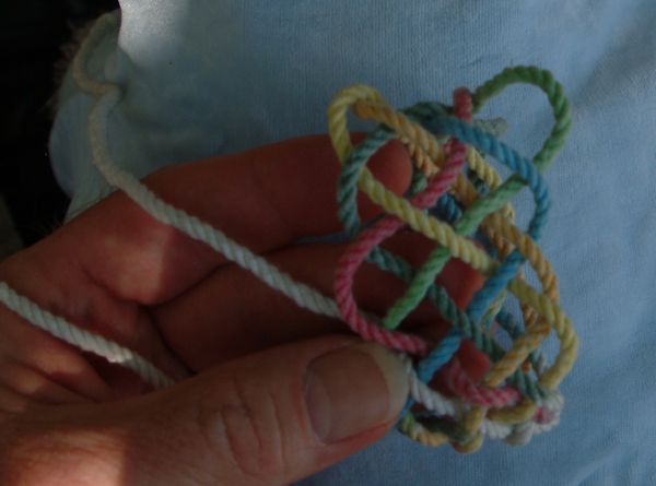 Tying a seven-lead twelve-bight knot in hand.