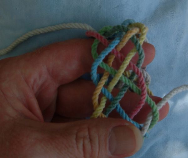 Tying a seven-lead twelve-bight knot in hand.