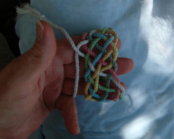 Tying a seven-lead twelve-bight knot in hand.